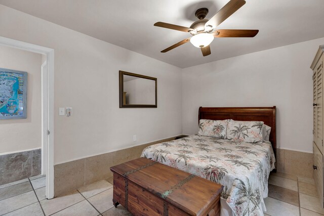 bedroom featuring light tile patterned flooring and ceiling fan