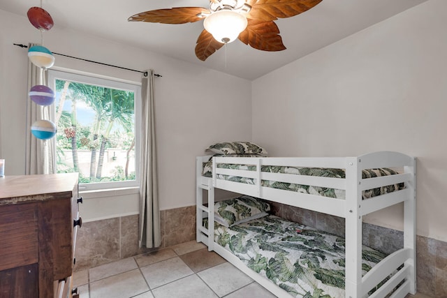 tiled bedroom with ceiling fan