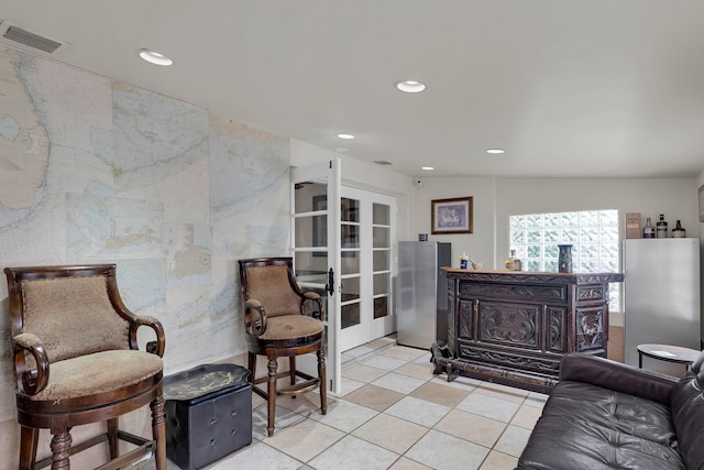 sitting room with light tile patterned floors and french doors