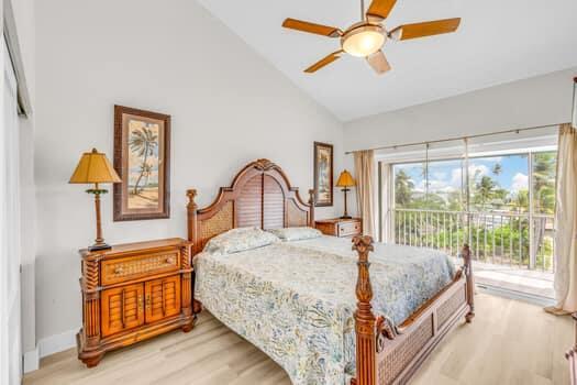 bedroom featuring vaulted ceiling, ceiling fan, access to exterior, and light wood-type flooring