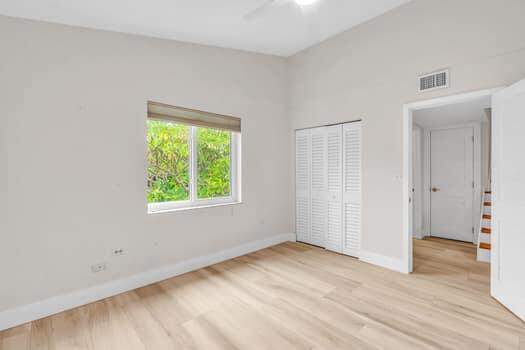 unfurnished bedroom with ceiling fan, a closet, and light hardwood / wood-style flooring