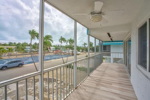 unfurnished sunroom featuring ceiling fan