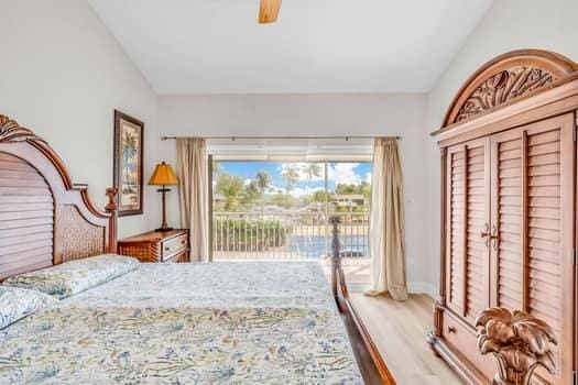 bedroom with vaulted ceiling, wood-type flooring, access to exterior, and ceiling fan