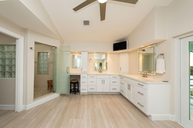 bathroom featuring vanity, lofted ceiling, a shower, and ceiling fan