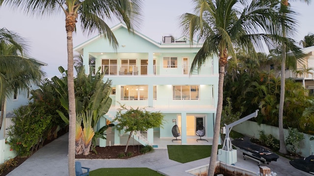 view of front of home with a patio area and a balcony