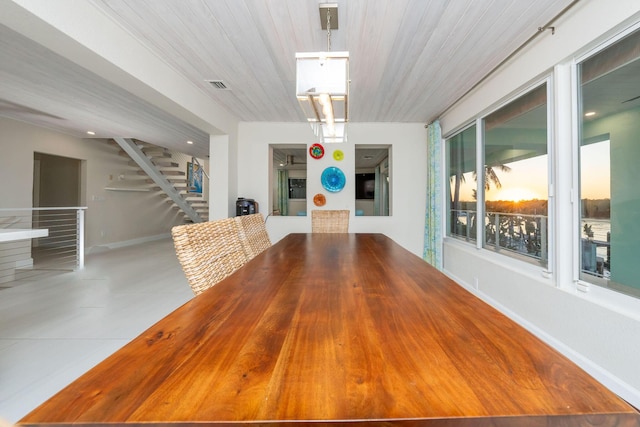 unfurnished dining area featuring wooden ceiling