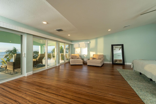 living room with dark hardwood / wood-style floors and a textured ceiling