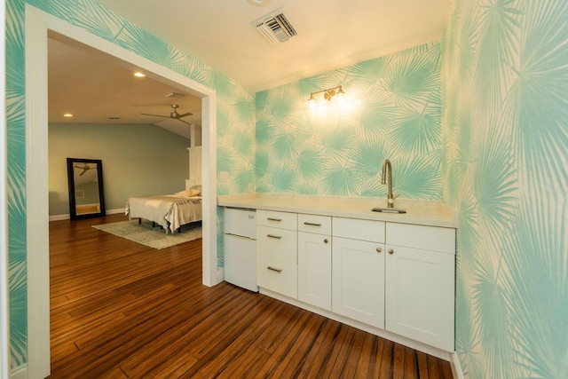 bathroom featuring vaulted ceiling and hardwood / wood-style floors