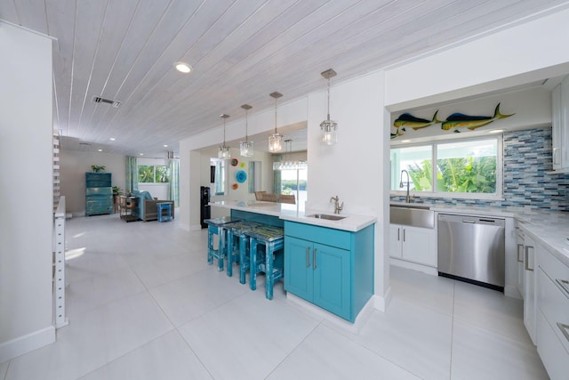 kitchen with blue cabinets, white cabinetry, dishwasher, sink, and hanging light fixtures