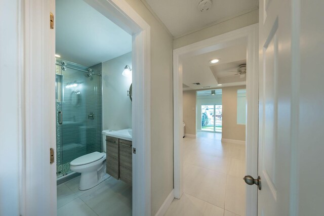 bathroom with ceiling fan, vanity, an enclosed shower, tile patterned floors, and toilet