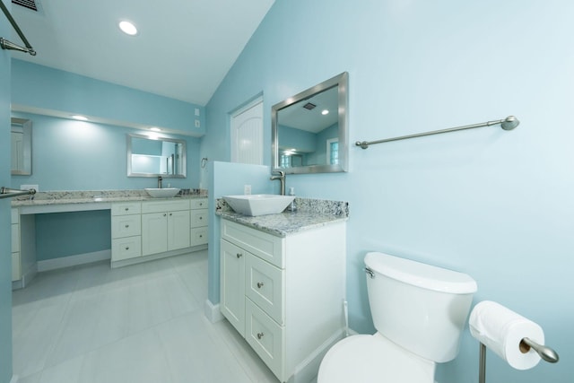 bathroom with lofted ceiling, vanity, tile patterned floors, and toilet