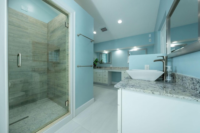 bathroom with tile patterned flooring, vanity, and an enclosed shower