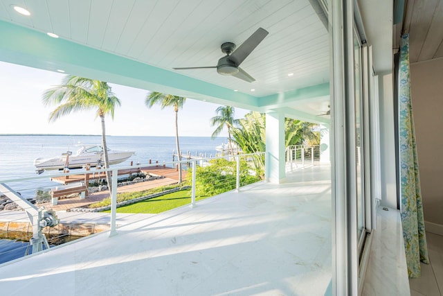 exterior space with plenty of natural light, ceiling fan, and a water view