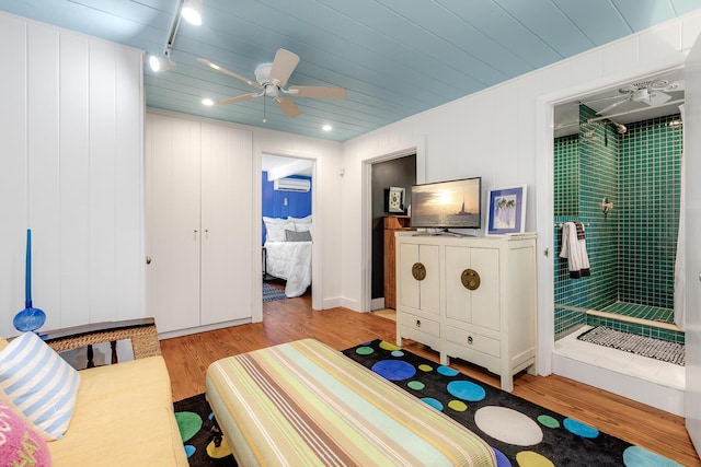 bedroom with light wood-style floors, wood ceiling, and ceiling fan