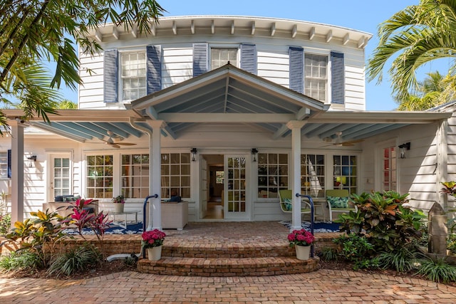 back of house featuring ceiling fan and a porch