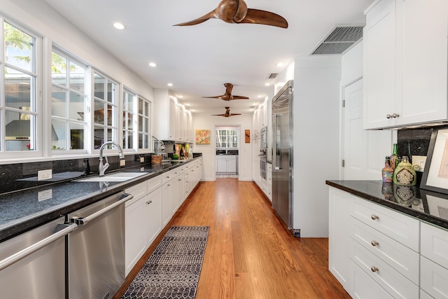 kitchen featuring a sink, visible vents, white cabinets, and stainless steel dishwasher