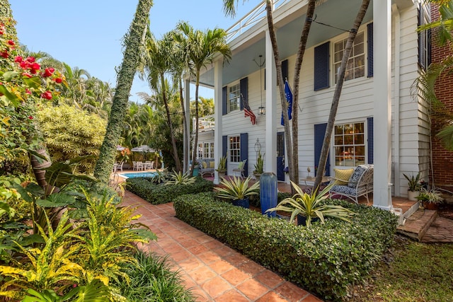 exterior space featuring a porch and an outdoor pool