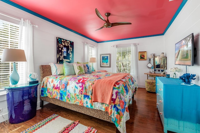 bedroom with ceiling fan, ornamental molding, and wood finished floors