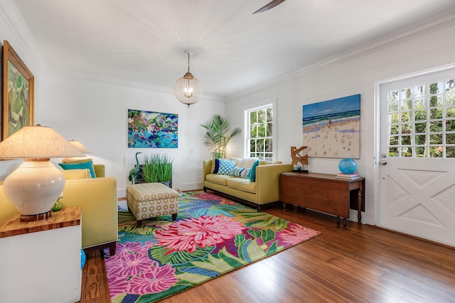 sitting room featuring ornamental molding and wood finished floors