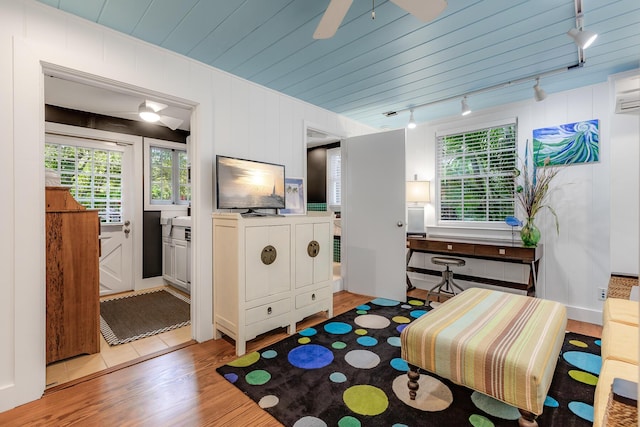 interior space featuring wood ceiling, light wood-style flooring, and ceiling fan