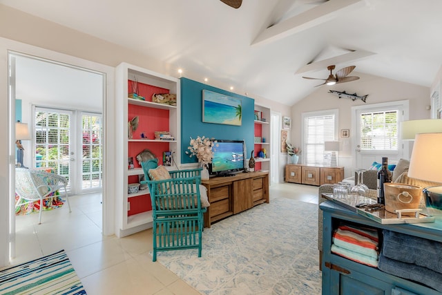 living area with light tile patterned floors, lofted ceiling with beams, ceiling fan, french doors, and built in shelves