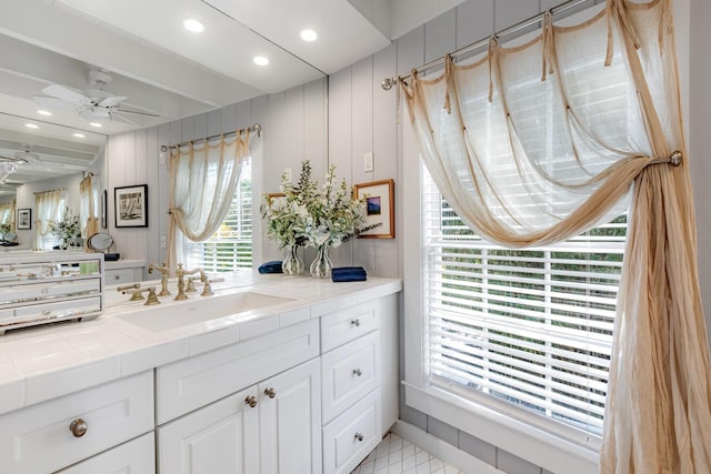 bathroom featuring beamed ceiling, vanity, a ceiling fan, and recessed lighting