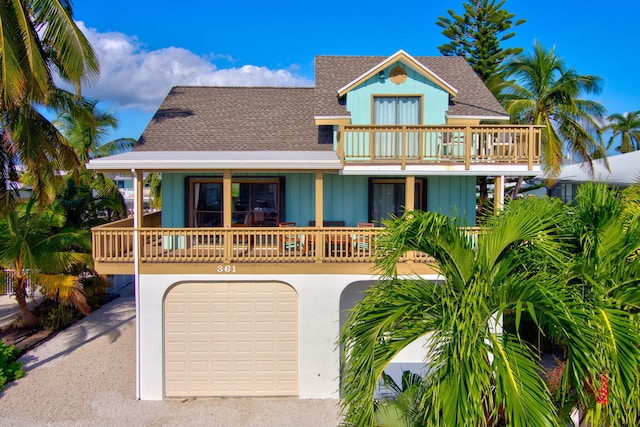 view of front facade with a garage and a balcony