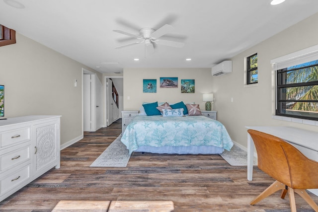 bedroom with ceiling fan, dark hardwood / wood-style floors, and a wall unit AC