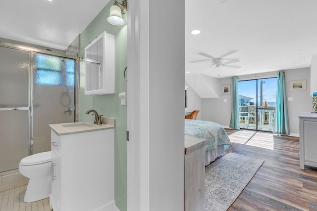 bedroom featuring sink, access to outside, hardwood / wood-style floors, and ceiling fan