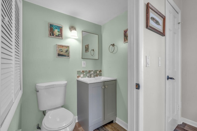 bathroom with vanity, wood-type flooring, and toilet