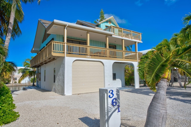 view of front of home featuring a garage and a balcony