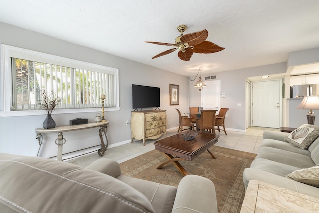 living room featuring ceiling fan and light tile patterned floors