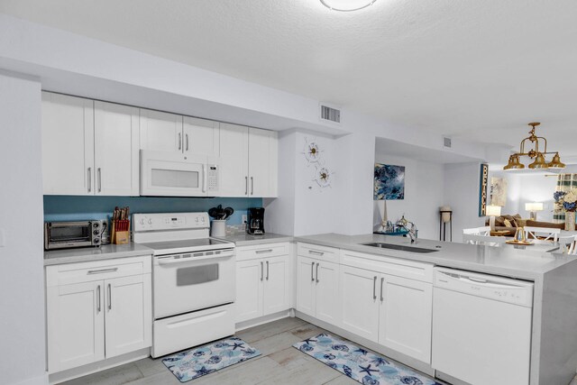 97501 Overseas Hwy Unit 705, Key Largo, FL 33037 - kitchen with white appliances, white cabinetry, light countertops, and a sink