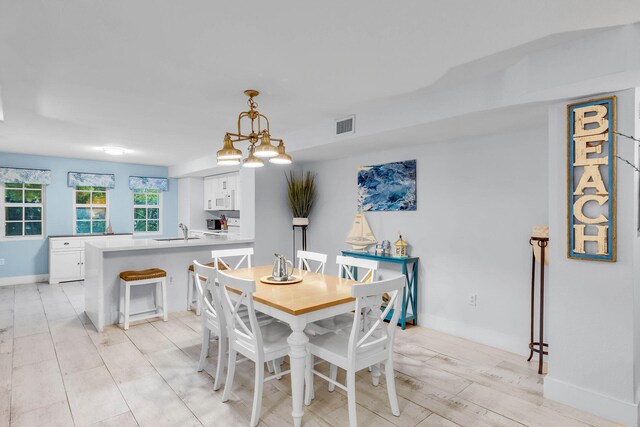 97501 Overseas Hwy Unit 705, Key Largo, FL 33037 - dining room with light wood finished floors, baseboards, and visible vents