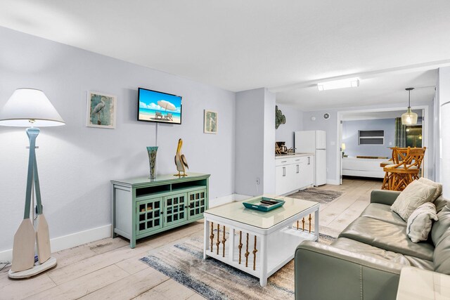 97501 Overseas Hwy Unit 705, Key Largo, FL 33037 - living area featuring light wood-type flooring and baseboards
