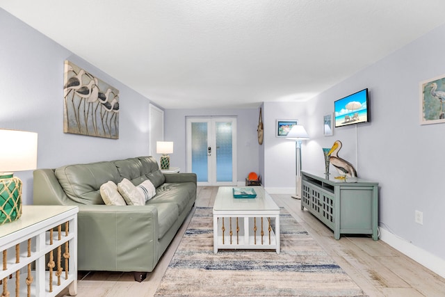 97501 Overseas Hwy Unit 705, Key Largo, FL 33037 - living room with french doors, light wood-style flooring, and baseboards