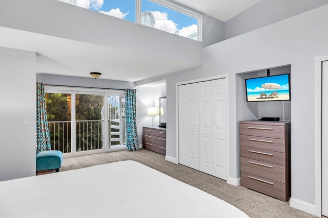 97501 Overseas Hwy Unit 705, Key Largo, FL 33037 - bedroom featuring light carpet, access to exterior, multiple windows, and baseboards