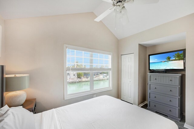 bedroom featuring lofted ceiling, a closet, and ceiling fan