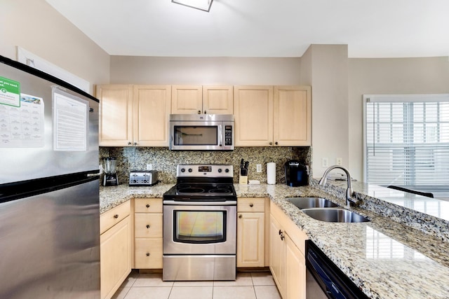 kitchen featuring sink, light tile patterned floors, stainless steel appliances, light stone counters, and decorative backsplash