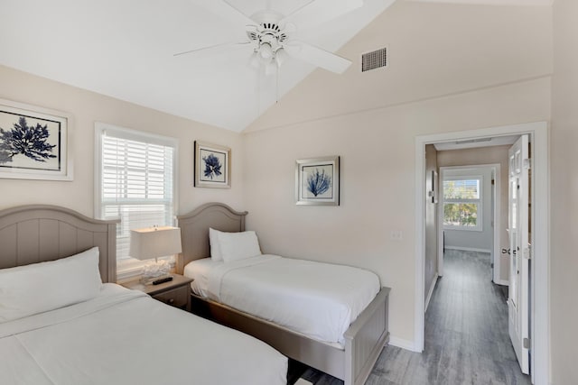 bedroom featuring ceiling fan, lofted ceiling, and light hardwood / wood-style floors