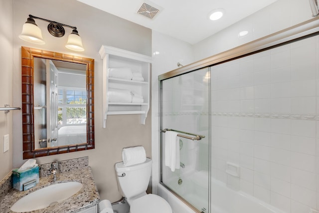 full bathroom with vanity, toilet, and combined bath / shower with glass door