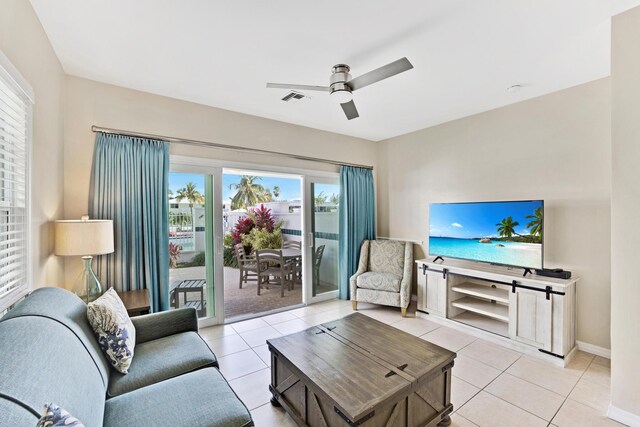 living room with ceiling fan and light tile patterned flooring