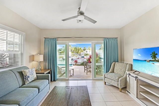 tiled living room with ceiling fan