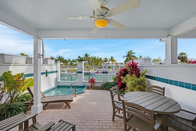 view of patio / terrace featuring an in ground hot tub and ceiling fan