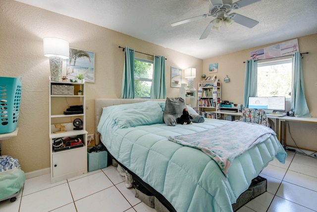 711 Sharon Pl, Key Largo, FL 33037 - bedroom featuring multiple windows, light tile patterned flooring, a textured ceiling, and a ceiling fan