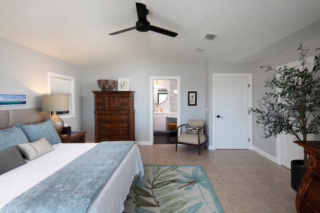 22 Floral Ave, Key Haven, FL 33040 - bedroom with ceiling fan, ensuite bathroom, vaulted ceiling, and light tile patterned floors