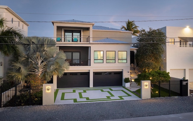 contemporary house with a garage and a balcony