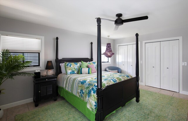 22 Floral Ave, Key Haven, FL 33040 - bedroom with multiple closets, light tile patterned flooring, and ceiling fan