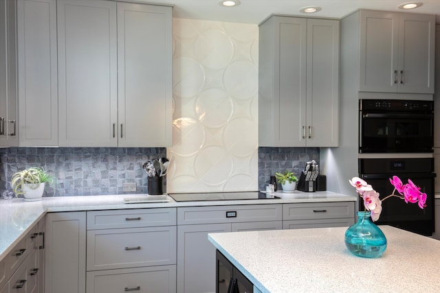 22 Floral Ave, Key Haven, FL 33040 - kitchen featuring gray cabinets, tasteful backsplash, and black appliances