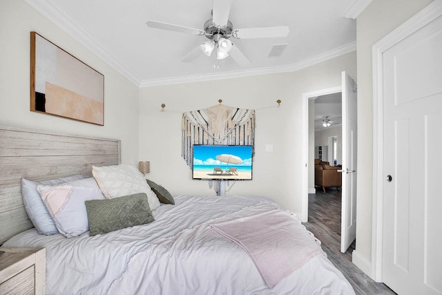 bedroom featuring ceiling fan, ornamental molding, and hardwood / wood-style floors